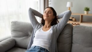 woman-leaning-back-on-couch-looking-comfortable