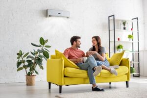 couple-on-yellow-couch-in-modern-living-room