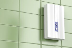tankless-water-heater-mounted-on-sage-green-tiles